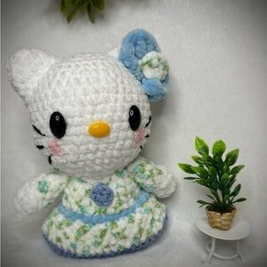 Handmade crocheted kitty in a floral dress with matching bow